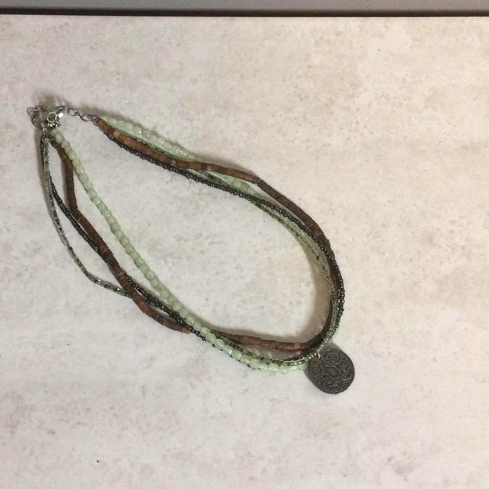 Aura four strand bead necklace with sun moon stars coin pendant